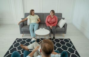 A couple attends a marriage counseling session in a modern and bright office setting.